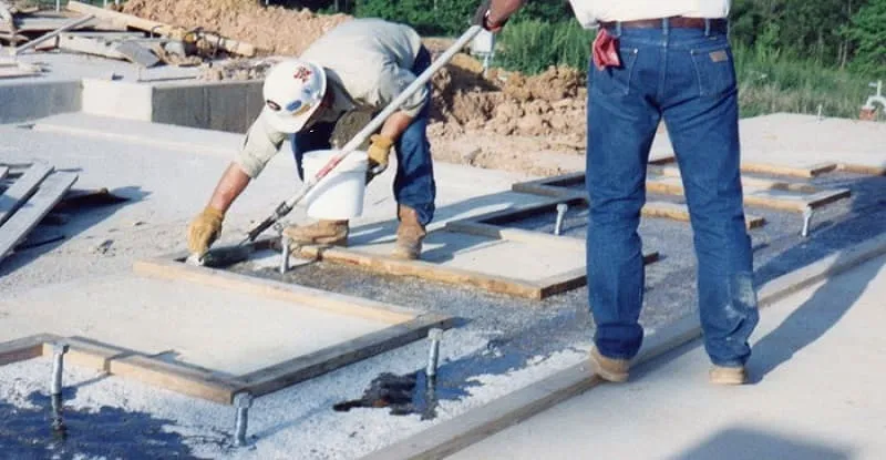 two men are grouting