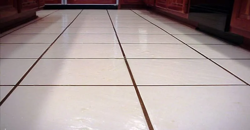 The tiles on the floor are grouted